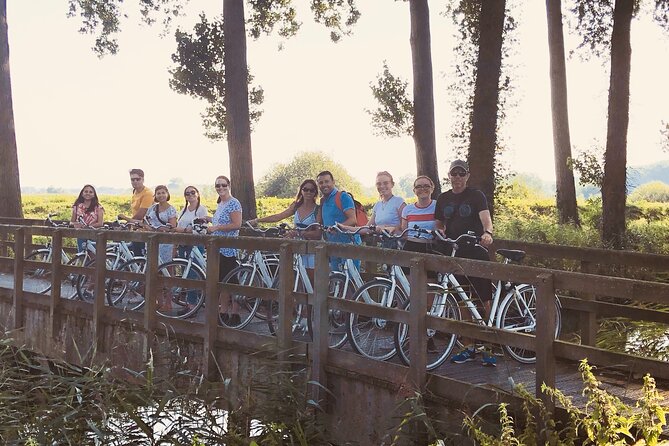 BikeTour Bruges & Damme in Spanish and English - Four Bruges windmills beside the canal