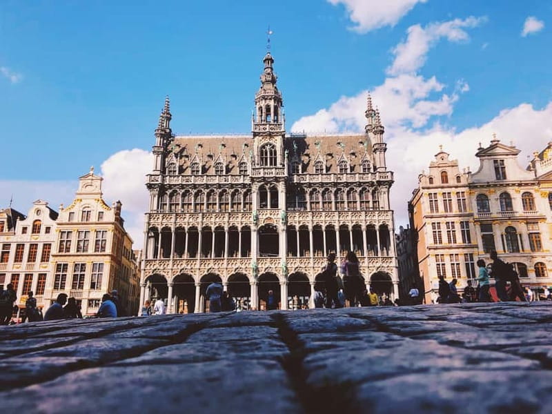 Brussels Highlights: Walking & Bus Tour with Waffle Tasting - Manneken Pis and the small scale of old Brussels